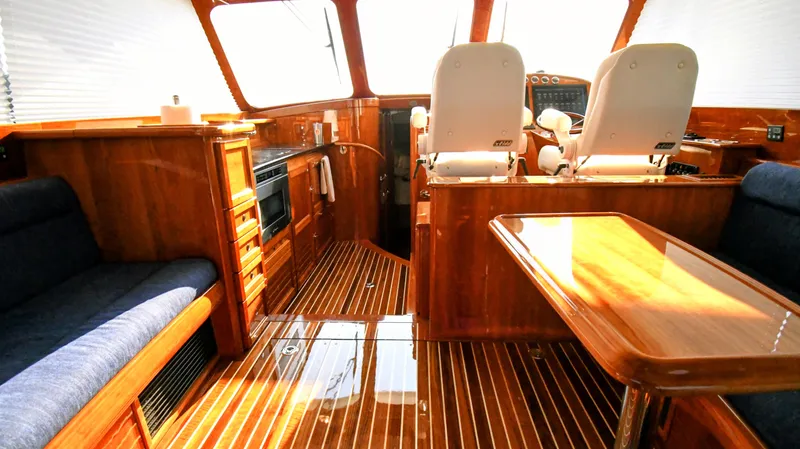 My Lisa Yacht Photos Pics Luxurious interior of 2022 Hinckley Talaria 43 yacht with wood finish and seating.