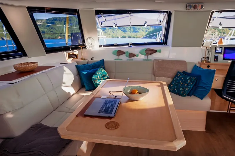Ruby Rose 2 Yacht Photos Pics Luxurious interior of 2023 Seawind 1370 catamaran with cozy seating and modern decor.