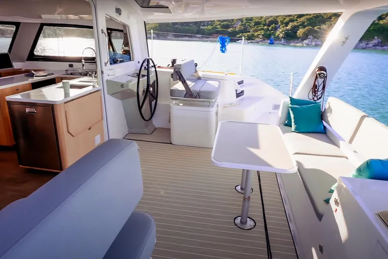 Ruby Rose 2 Yacht Photos Pics Luxurious 2023 Seawind 1370 catamaran interior with modern kitchen and seating area.