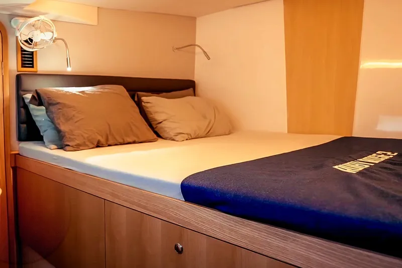 Ruby Rose 2 Yacht Photos Pics Cozy cabin interior of 2023 Seawind 1370 yacht with comfortable bedding.