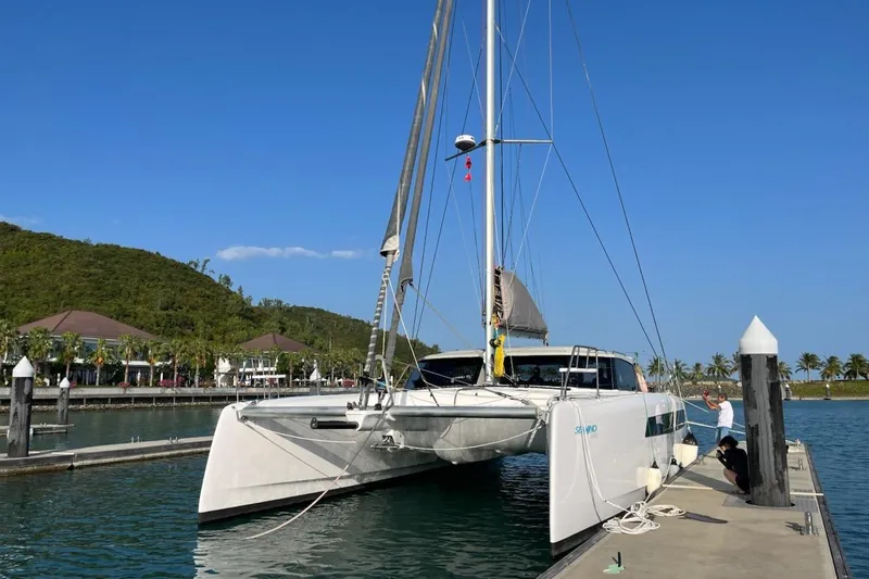 Ruby Rose 2 Yacht Photos Pics 2023 Seawind 1370 catamaran docked at a marina under clear blue skies.