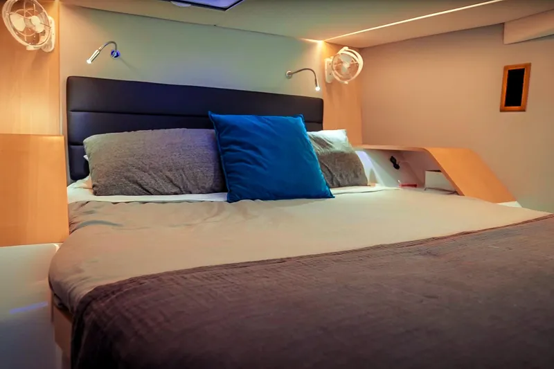 Ruby Rose 2 Yacht Photos Pics Luxurious bedroom interior of 2023 Seawind 1370 yacht with modern lighting and cozy bedding.