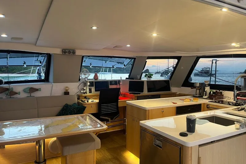 Ruby Rose 2 Yacht Photos Pics Luxurious interior of 2023 Seawind 1370 catamaran with modern kitchen and panoramic windows.