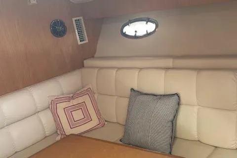 "moxie" Yacht Photos Pics 1998 Tiara Yachts 35 Open Hardtop interior with cushioned seating and decorative pillows.
