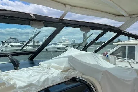 "moxie" Yacht Photos Pics 1998 Tiara Yachts 35 Open Hardtop at marina, covered interior, clear sky.