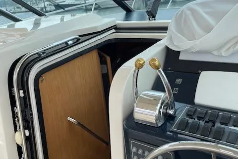"moxie" Yacht Photos Pics 1998 Tiara Yachts 35 Open Hardtop helm with controls and cabin door.