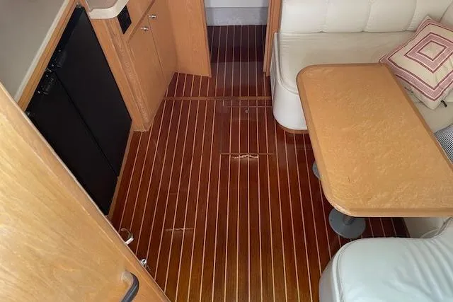 "moxie" Yacht Photos Pics Interior of 1998 Tiara Yachts 35 Open Hardtop with wooden flooring and seating area.