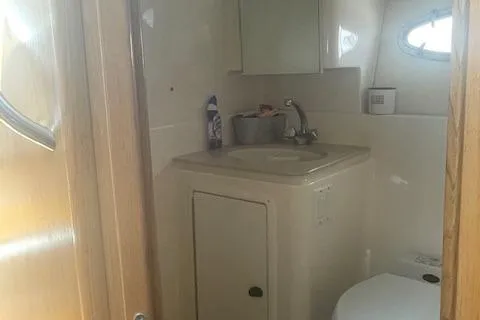 "moxie" Yacht Photos Pics 1998 Tiara Yachts 35 Open Hardtop bathroom with sink, mirror, and window.