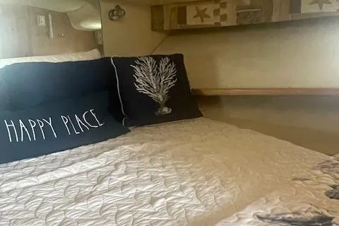 "moxie" Yacht Photos Pics Cozy cabin interior of 1998 Tiara Yachts 35 Open Hardtop with decorative pillows.