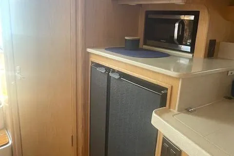 "moxie" Yacht Photos Pics Interior of 1998 Tiara Yachts 35 Open Hardtop, featuring kitchen appliances and cabinetry.