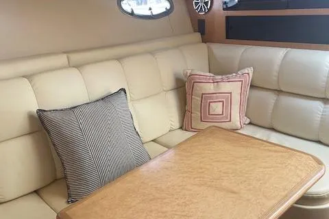 "moxie" Yacht Photos Pics 1998 Tiara Yachts 35 Open Hardtop interior with beige seating and decorative pillows.
