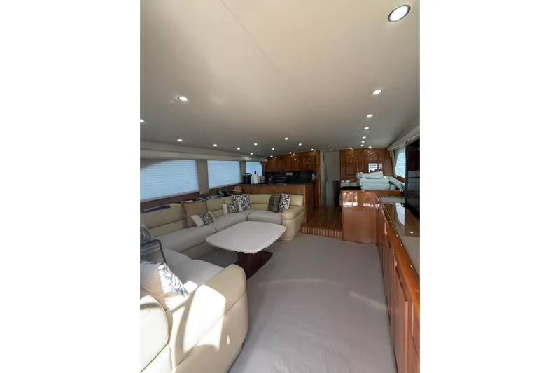 Kickback Yacht Photos Pics Luxurious interior of 2004 Viking 65 Convertible yacht with plush seating and elegant wood finishes.