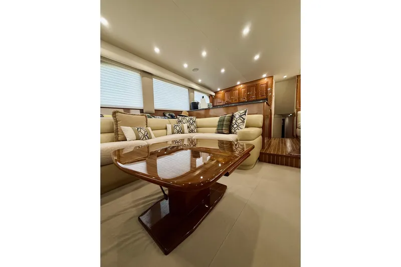 Kickback Yacht Photos Pics Luxurious interior of 2004 Viking 65 Convertible yacht with elegant seating and wooden table.