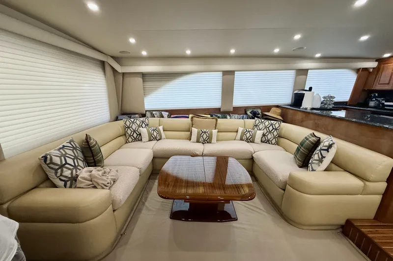 Kickback Yacht Photos Pics Luxurious interior of a 2004 Viking 65 Convertible yacht with plush seating and elegant decor.