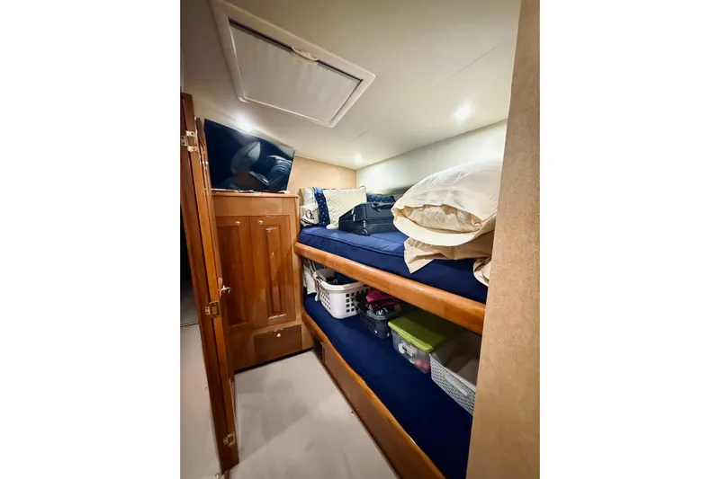 Kickback Yacht Photos Pics Interior of 2004 Viking 65 Convertible yacht with bunk beds and storage.