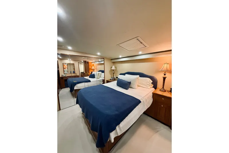 Kickback Yacht Photos Pics Luxurious bedroom interior of 2004 Viking 65 Convertible yacht with elegant decor.