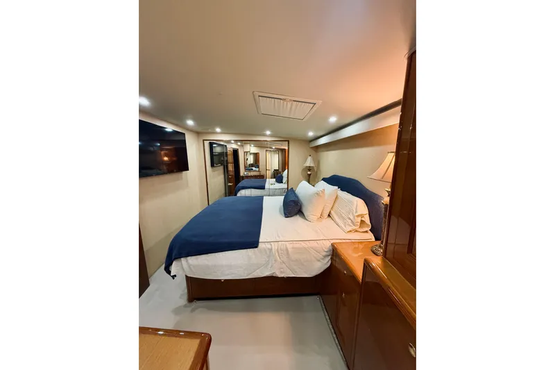 Kickback Yacht Photos Pics Luxurious bedroom interior of 2004 Viking 65 Convertible yacht with elegant furnishings.