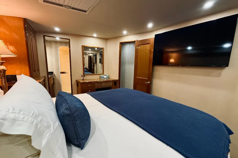 Kickback Yacht Photos Pics Luxurious bedroom interior of 2004 Viking 65 Convertible yacht with modern amenities.