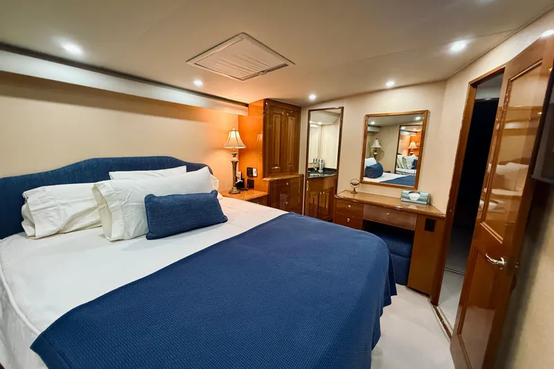Kickback Yacht Photos Pics Luxurious bedroom interior of 2004 Viking 65 Convertible yacht with elegant furnishings.