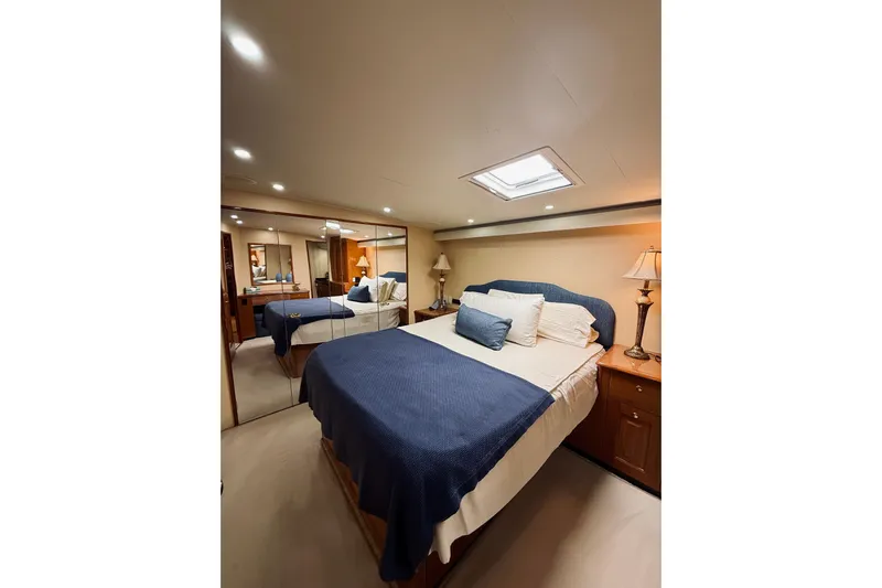 Kickback Yacht Photos Pics Luxurious bedroom interior of 2004 Viking 65 Convertible yacht with elegant decor.