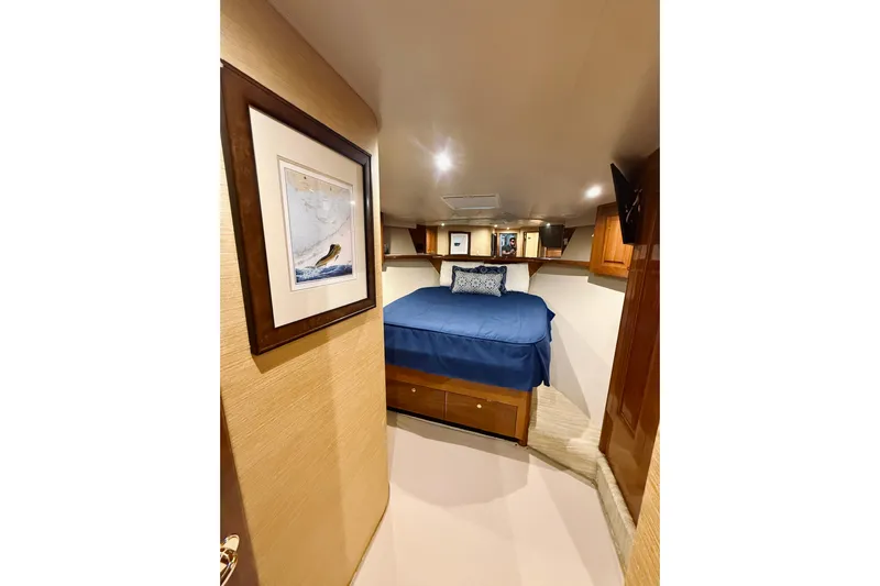 Kickback Yacht Photos Pics Luxurious cabin interior of 2004 Viking 65 Convertible yacht with cozy bed and elegant decor.