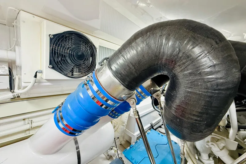 Kickback Yacht Photos Pics Engine room of 2004 Viking 65 Convertible with ventilation system and insulated pipes.