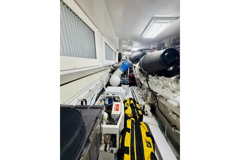 Kickback Yacht Photos Pics Engine room of 2004 Viking 65 Convertible yacht, featuring mechanical components and equipment.