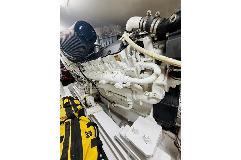 Kickback Yacht Photos Pics Engine room of a 2004 Viking 65 Convertible yacht, showcasing a powerful marine engine.
