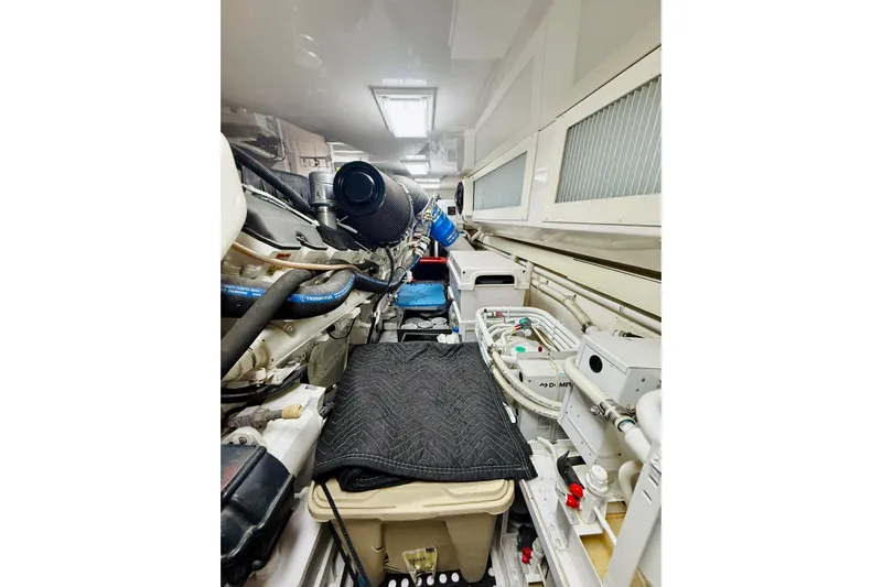 Kickback Yacht Photos Pics Engine room of a 2004 Viking 65 Convertible yacht, showcasing mechanical components and equipment.