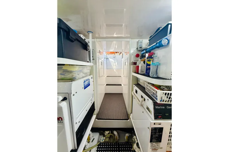 Kickback Yacht Photos Pics Engine room of 2004 Viking 65 Convertible yacht, featuring organized storage and equipment.