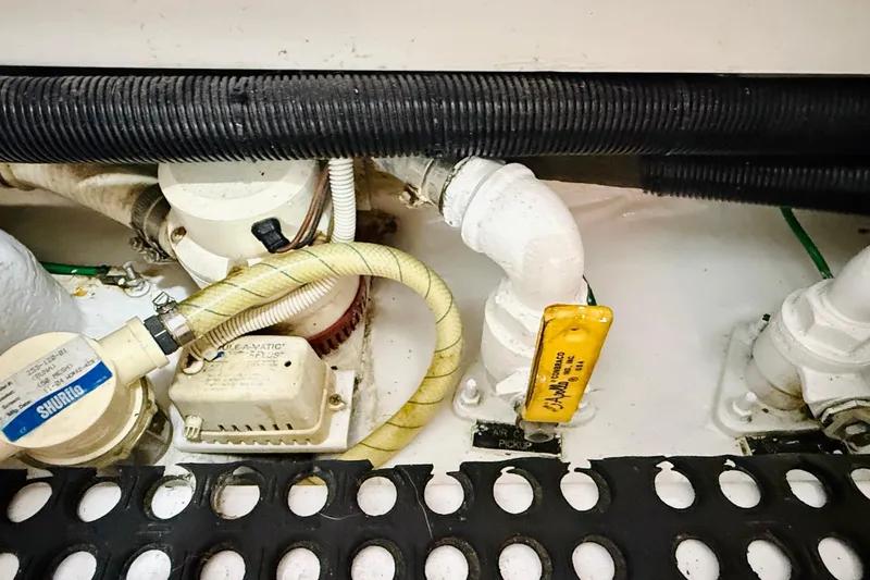 Kickback Yacht Photos Pics Engine room components of a 2004 Viking 65 Convertible yacht, featuring hoses and fittings.