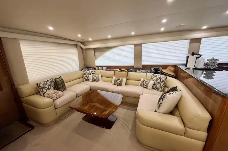 Kickback Yacht Photos Pics Luxurious interior of 2004 Viking 65 Convertible yacht with plush seating and elegant decor.