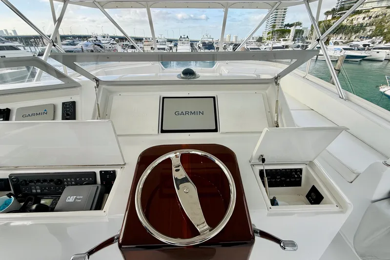 Kickback Yacht Photos Pics 2004 Viking 65 Convertible yacht helm with Garmin navigation system, docked at marina.
