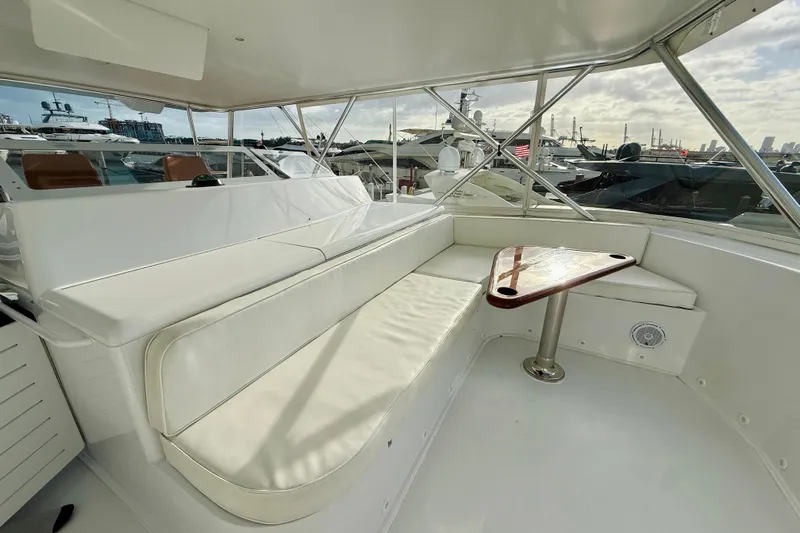 Kickback Yacht Photos Pics Luxurious seating area on a 2004 Viking 65 Convertible yacht, featuring a sleek design.