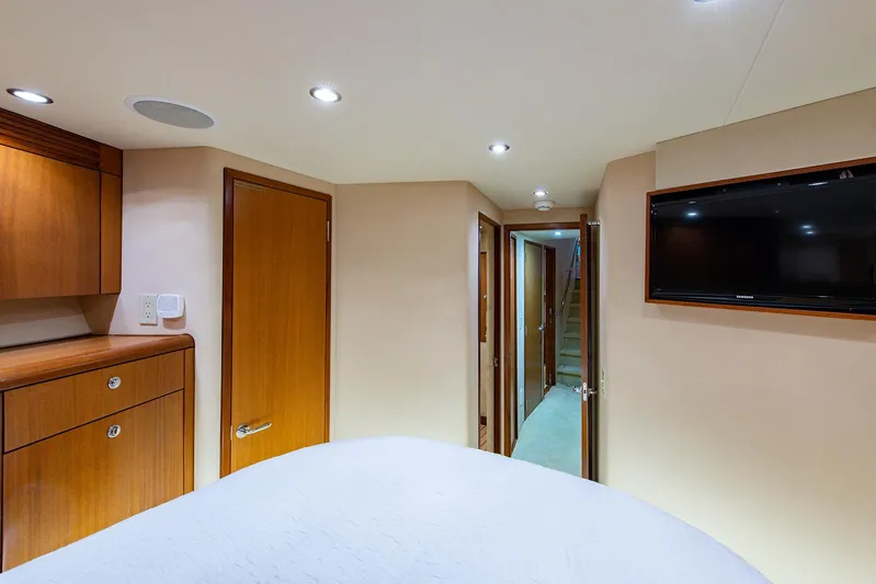  Yacht Photos Pics Interior of 2006 Hatteras 64 Convertible yacht, featuring wood cabinetry and a wall-mounted TV.