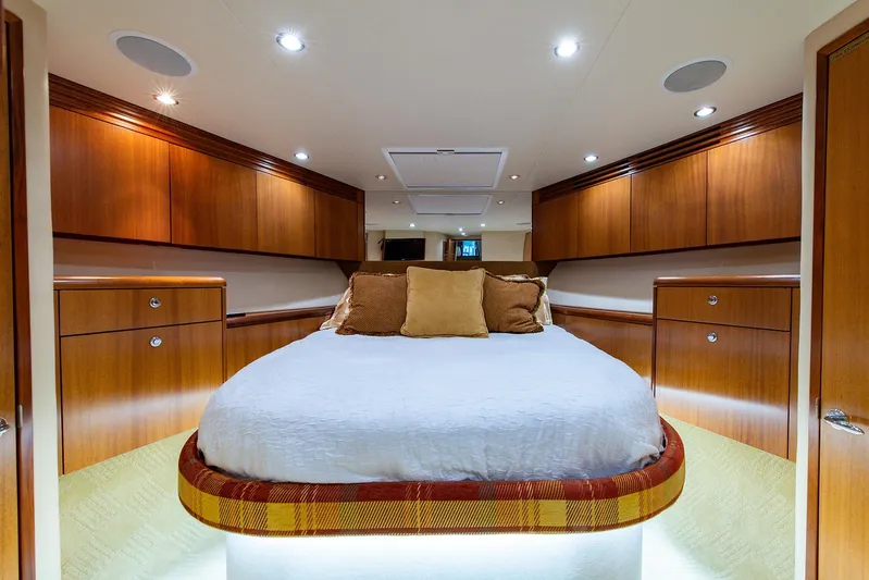  Yacht Photos Pics Luxurious cabin interior of 2006 Hatteras 64 Convertible yacht with elegant wood finish.