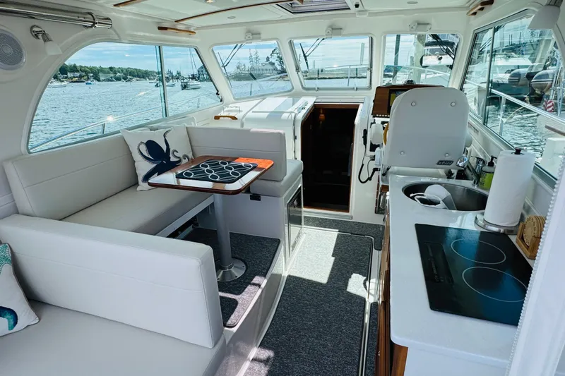 Yacht Photos Pics Interior of 2025 Back Cove 34O yacht with seating, table, and kitchenette.