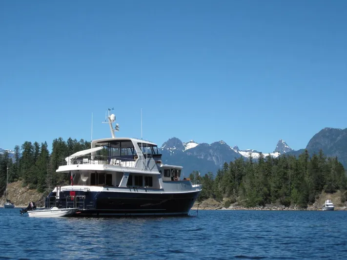 Ardreen Yacht Photos Pics Selene 62 Ocean Trawler 2005 on scenic lake with mountain backdrop.