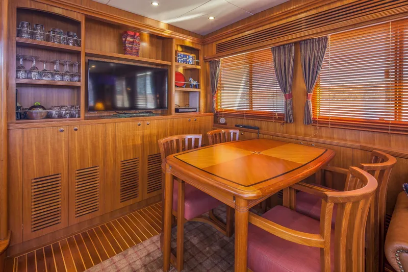 Ardreen Yacht Photos Pics Luxurious interior of 2005 Selene 62 Ocean Trawler with wooden dining area and built-in cabinetry.
