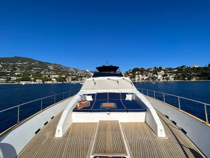 Lady Amanda Yacht Photos Pics Luxury 2006 Couach 2800 yacht on serene water with scenic coastal backdrop.