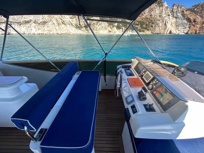 Lady Amanda Yacht Photos Pics Luxury 2006 Couach 2800 yacht interior with blue seating and scenic ocean view.