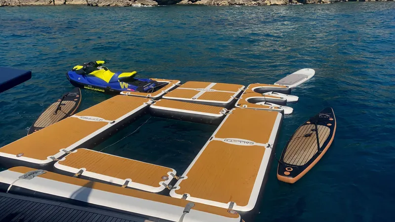 Lady Amanda Yacht Photos Pics Floating dock with jet ski and paddleboards near Couach 2800 yacht, 2006 model.