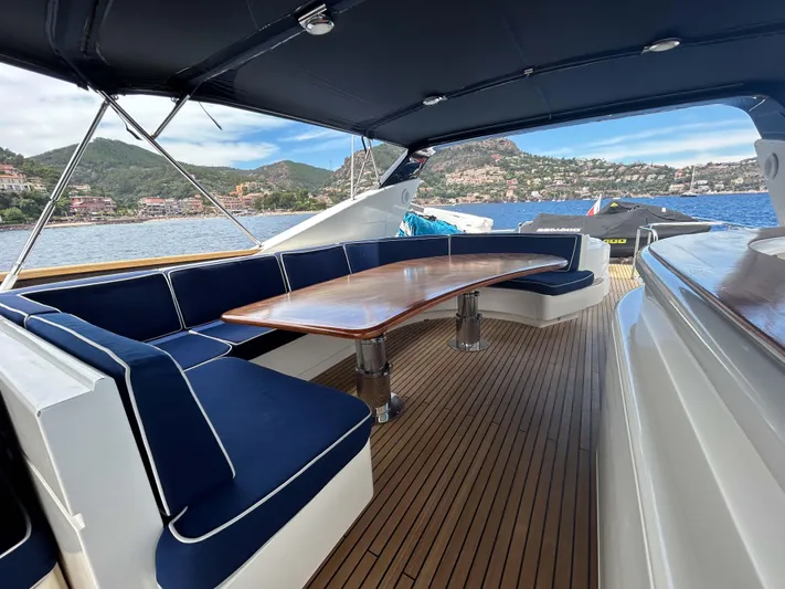 Lady Amanda Yacht Photos Pics Luxurious 2006 Couach 2800 yacht deck with elegant seating and scenic ocean view.