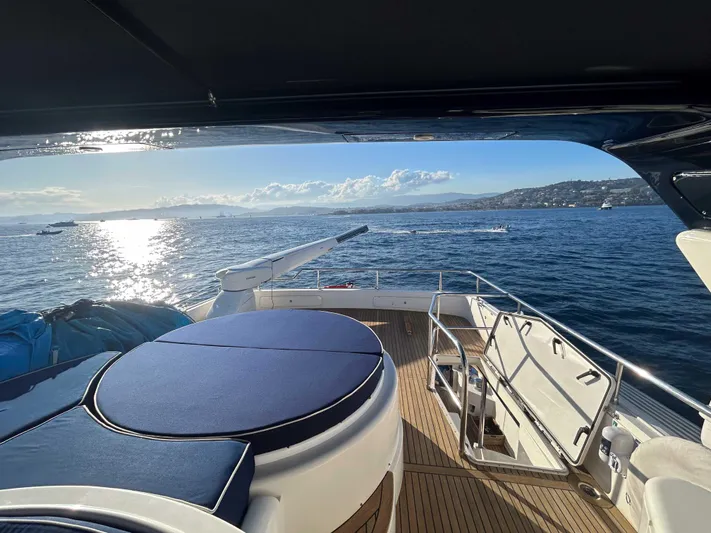 Lady Amanda Yacht Photos Pics Couach 2800 yacht deck view, 2006 model, overlooking serene ocean and coastline.