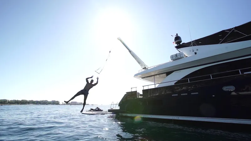 Lady Amanda Yacht Photos Pics Person jumping off 2006 Couach 2800 yacht into the sea.