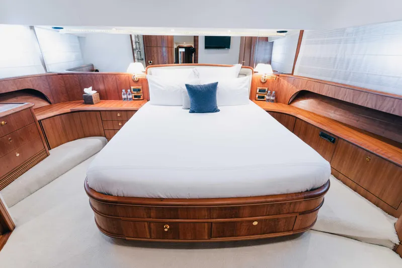 Lady Amanda Yacht Photos Pics Luxurious bedroom interior of 2006 Couach 2800 yacht with elegant wood finish.