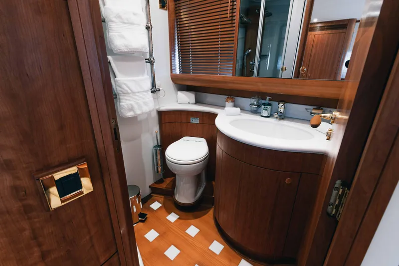 Lady Amanda Yacht Photos Pics Luxurious bathroom in 2006 Couach 2800 yacht with wooden cabinetry and modern fixtures.