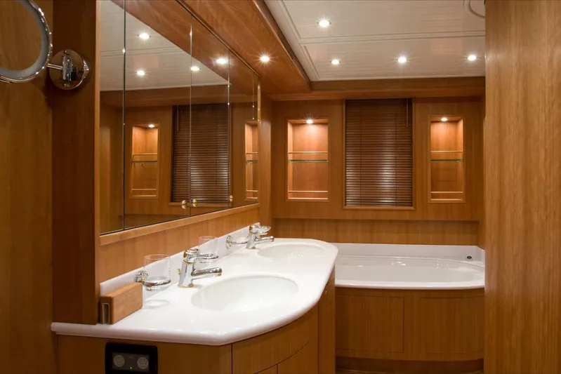 Lady Amanda Yacht Photos Pics Luxurious bathroom in 2006 Couach 2800 yacht with double sinks and wooden accents.
