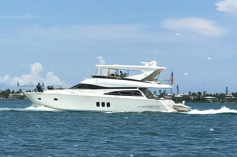 Amarone Yacht Photos Pics 2008 Neptunus 62 Motoryacht cruising on open water under a clear blue sky.