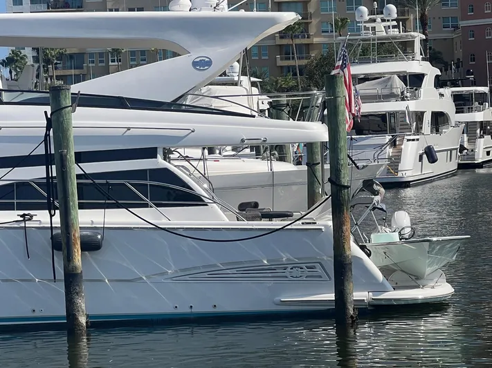 Amarone Yacht Photos Pics 2008 Neptunus 62 Motoryacht docked in a marina, surrounded by other luxury boats.